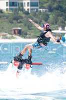 Flyboarder with arms out falling over backwards
