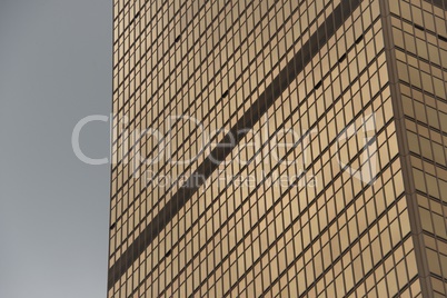 Geometric pattern of windows on gold skyscraper