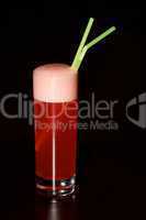 Glass of red sherbet with green straws