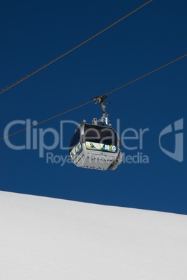 Gondola in blue sky over white snow