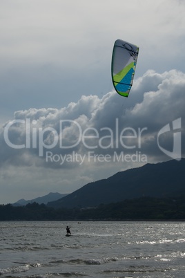 Kite surfer with green and blue kite