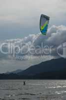 Kite surfer with green and blue kite