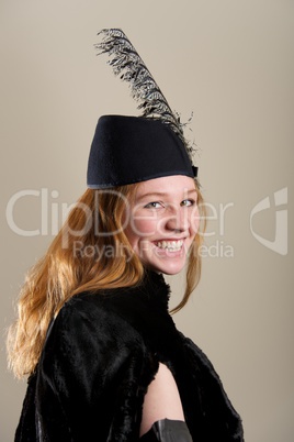 Laughing redhead in feathered hat and coat
