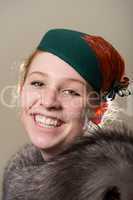 Laughing redhead in green hat and fur