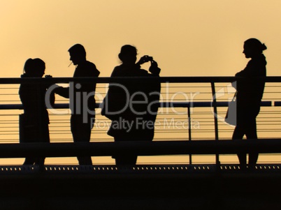 Millennium Bridge tourists at sunset