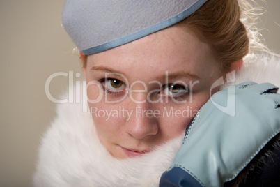 Redhead close-up in blue felt hat and fur