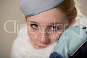 Redhead close-up in blue felt hat and fur