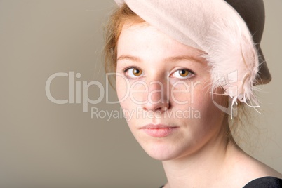 Redhead close-up in feathered cream felt hat