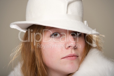 Redhead close-up in white felt hat and fur