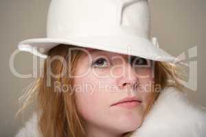 Redhead close-up in white felt hat and fur