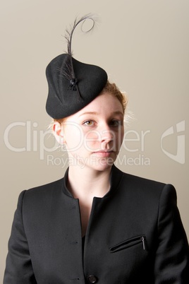Redhead in black jacket and feathered hat