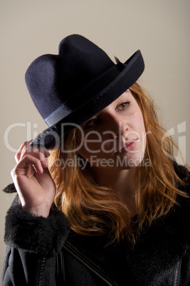 Redhead in black hat with head tilted