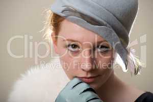 Redhead in blue feathered felt hat and fur