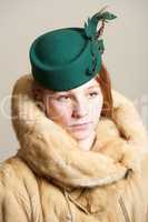 Redhead in fur coat and green hat