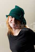 Redhead in green hat and black top