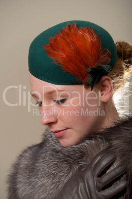 Redhead in green feathered hat and fur