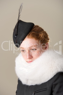 Redhead in hat and fur looking down