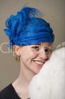 Redhead in hat resting cheek on fur