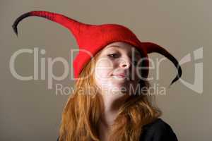 Redhead in red hat looking down nose