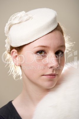 Redhead in white felt hat and fur