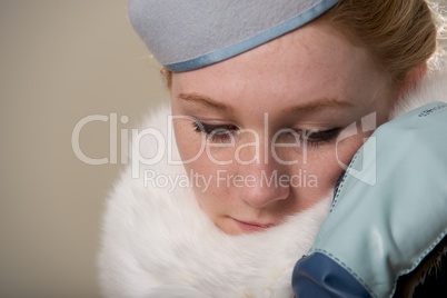 Redhead looking down in blue felt hat and fur