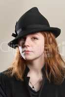 Redhead serious in black hat and jacket