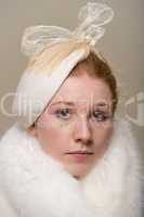 Redhead serious in white hat with bow and fur