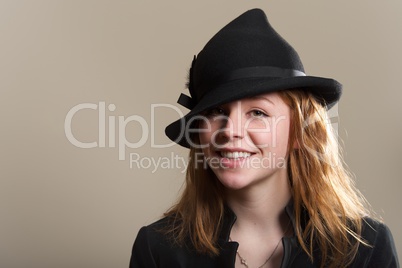 Redhead smiling in black hat and jacket