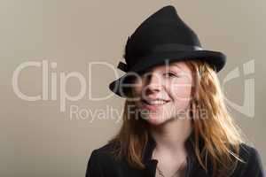 Redhead smiling in black hat and jacket