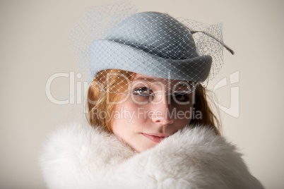 Redhead smiling in blue veiled hat and fur