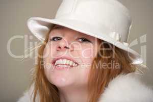 Redhead smiling in white felt hat and fur