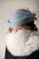 Redhead staring in blue veiled hat and fur