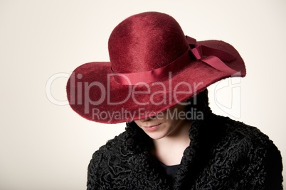 Redhead with face hidden by maroon hat