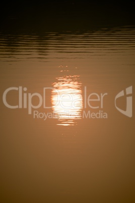 Reflection of setting sun in lake