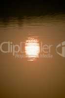 Reflection of setting sun in lake