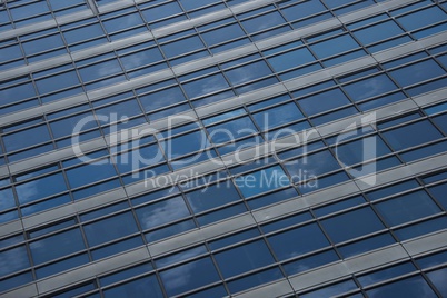Reflections of clouds in blue glass skyscraper