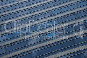 Reflections of clouds in blue glass skyscraper