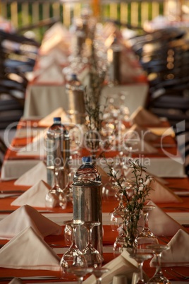 Restaurant table laid with glassware and cutlery Restaurant table laid with glassware and cutlery