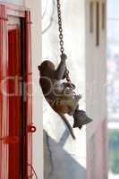 Rhesus macaque swinging on a bell chain