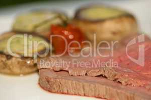 Roast beef with tomato and stuffed mushrooms