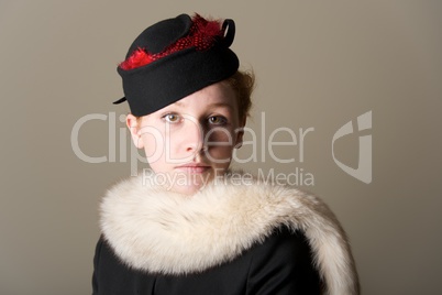 Serious redhead in black hat and fur