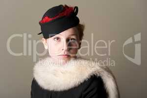 Serious redhead in black hat and fur