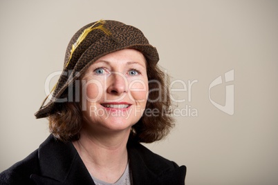 Smiling brunette in black and brown hat