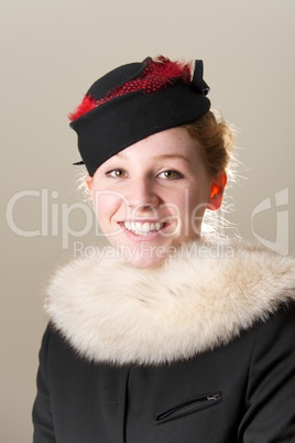 Smiling redhead in black and red hat