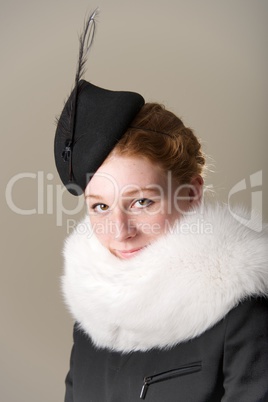 Smiling redhead in black hat and fur