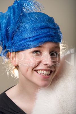 Smiling redhead in blue hat and fur