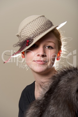 Smiling redhead in grey hat and fur