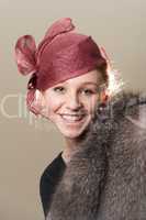 Smiling redhead in mesh hat and fur