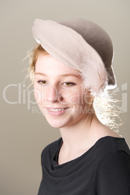 Smiling redhead in taupe hat looking down