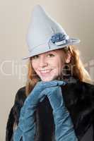 Smiling redhead with blue suede gloved hands